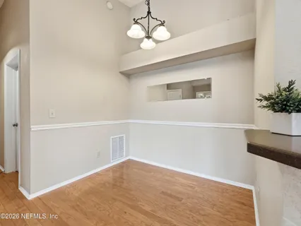 an empty room with a ceiling fan and a window