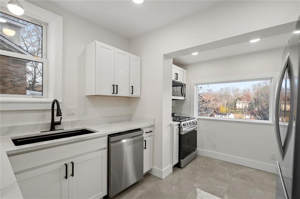 17 Wilkins Road Forest Hills, PA 15221 - Photo 12 of 24 a kitchen with granite countertop white cabinets and stainless steel appliances