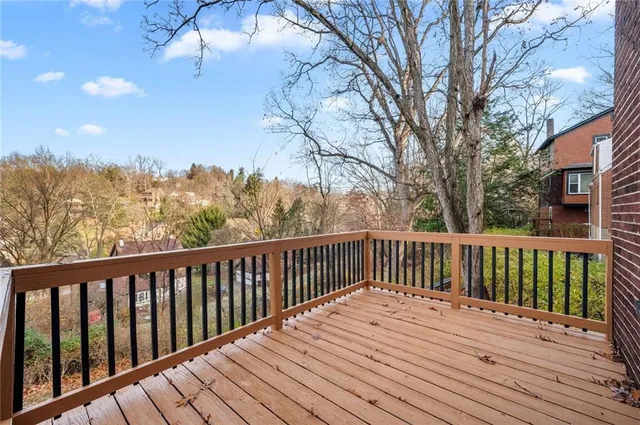 a balcony with wooden floor and fence