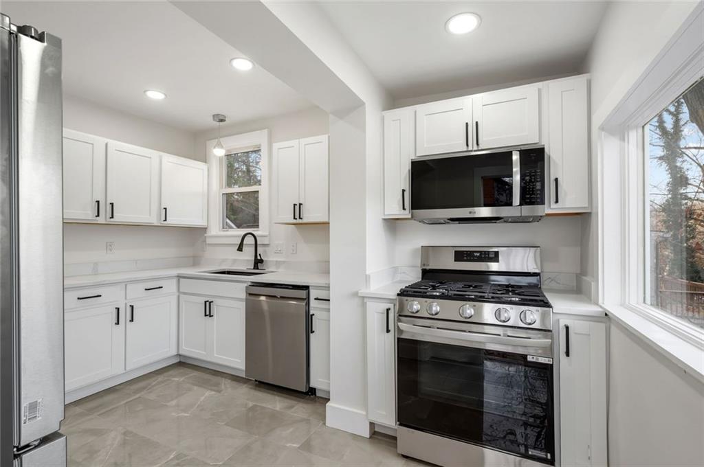 17 Wilkins Road Forest Hills, PA 15221 - Photo 9 of 24 a kitchen with stainless steel appliances a stove microwave and sink