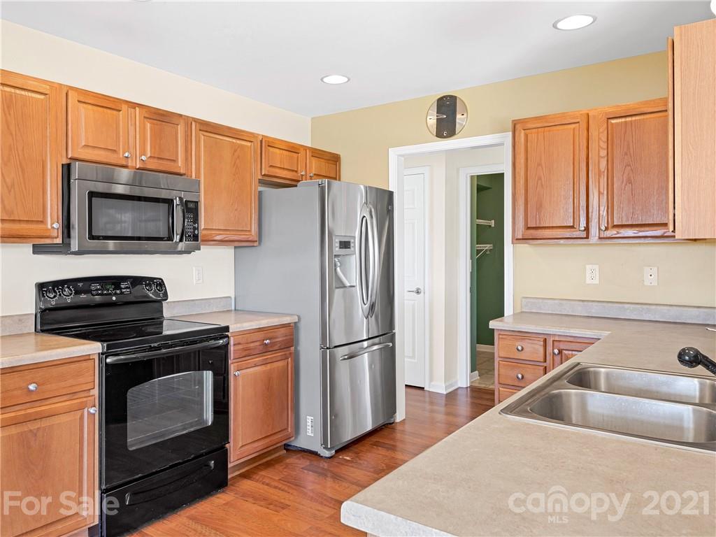 189 Black River Road Fletcher, NC 28732 - Photo 12 of 28 a kitchen with stainless steel appliances a stove microwave and refrigerator