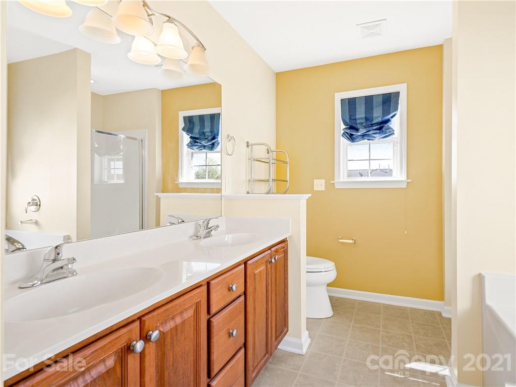 189 Black River Road Fletcher, NC 28732 - Photo 15 of 28 a bathroom with a double vanity sink toilet and a mirror