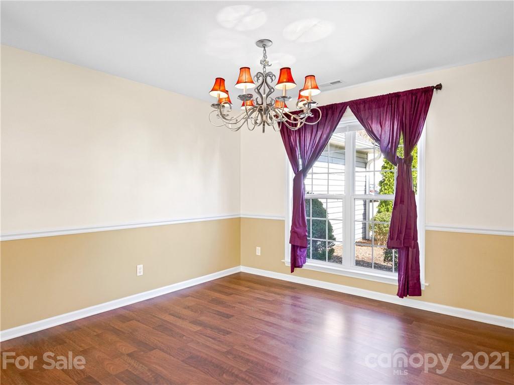 189 Black River Road Fletcher, NC 28732 - Photo 6 of 28 a view of a room with wooden floor and chandelier