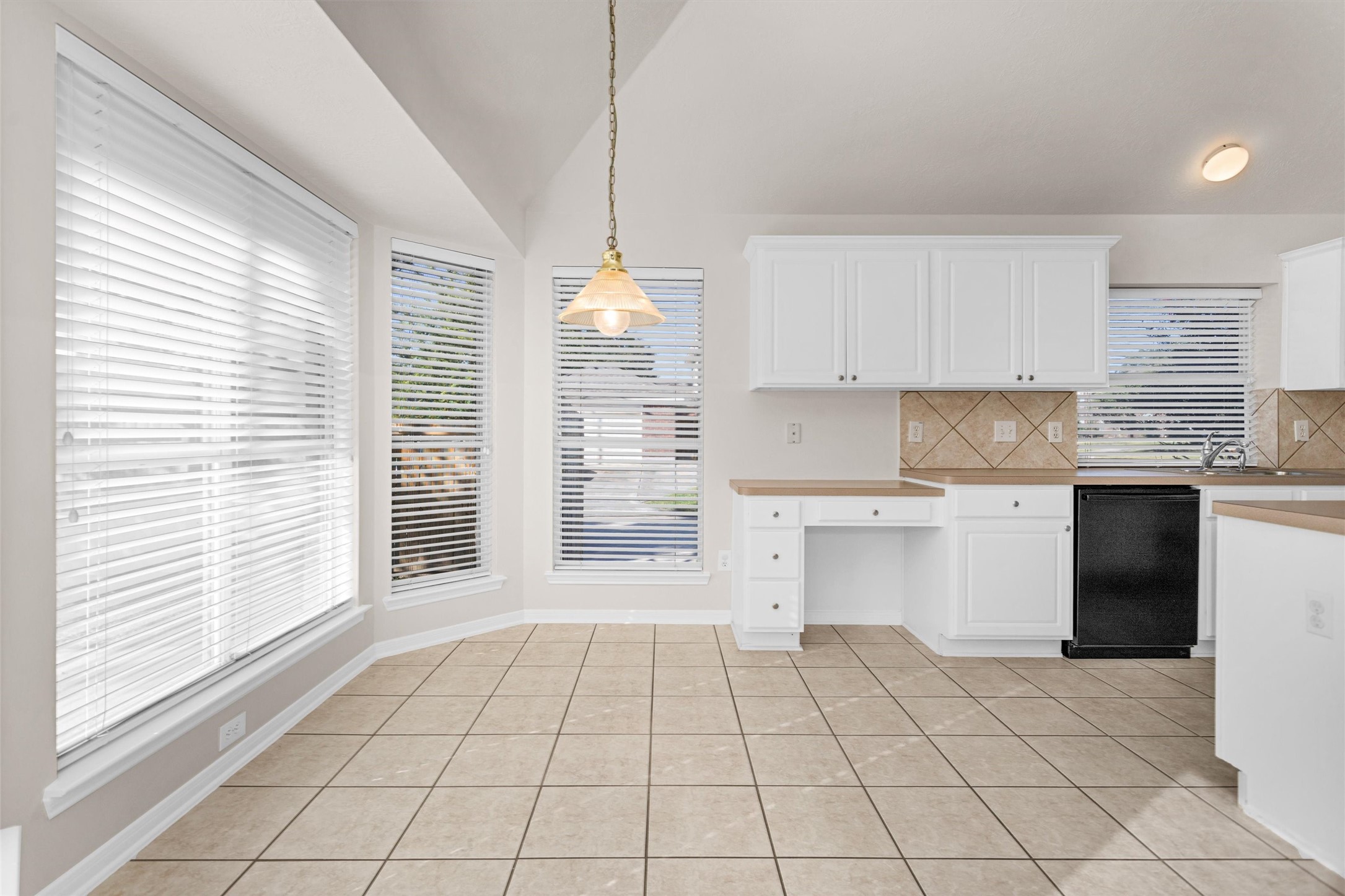 2615 Honeysuckle Walk Spring, TX 77388 - Photo 14 of 39 a kitchen with a stove a sink and a window