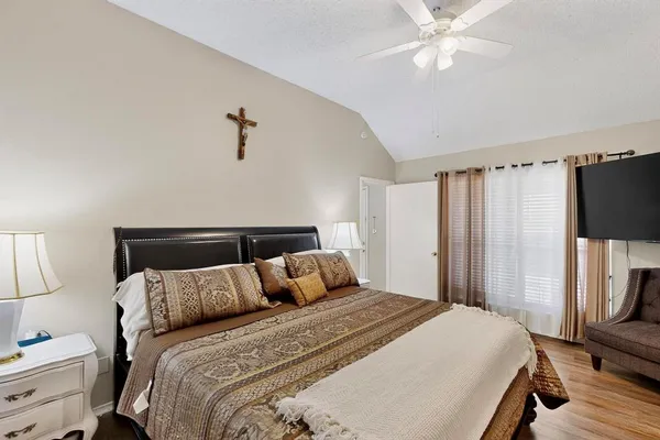 a bedroom with a bed and a flat screen tv