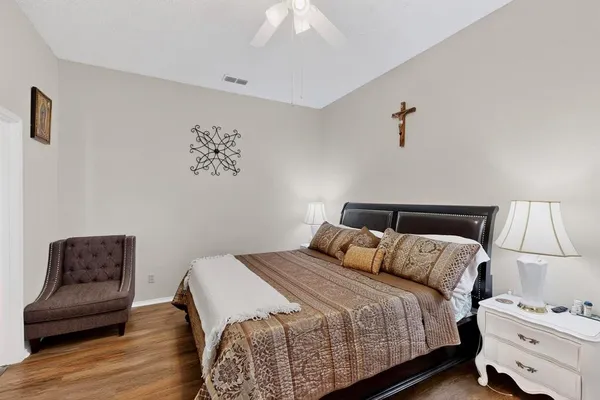a bedroom with bed and a chandelier