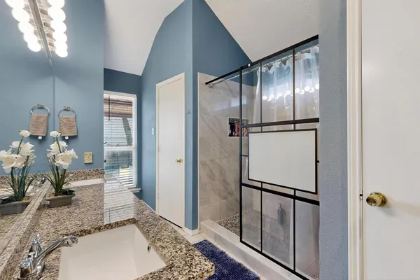 a bedroom with a bed and a couch