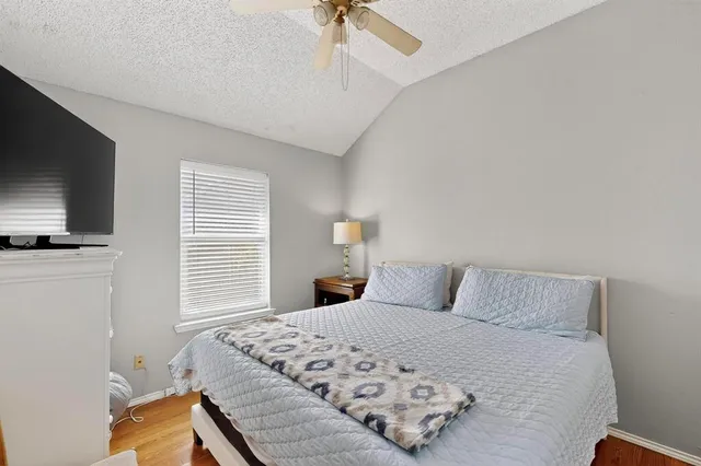 a bathroom with a granite countertop sink a large mirror and a shower