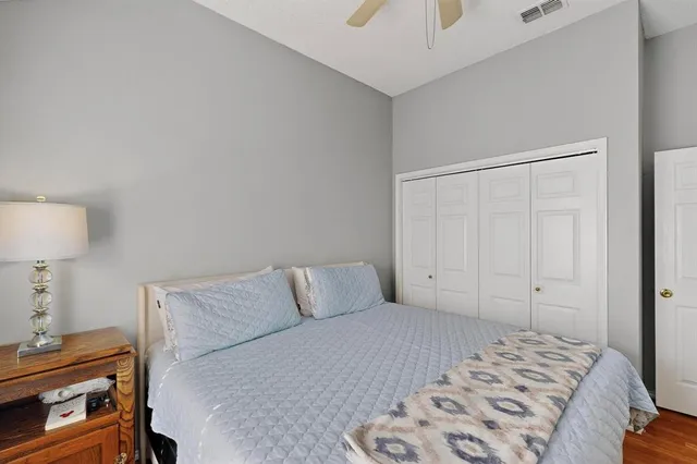 a bedroom with a bed and flat screen tv