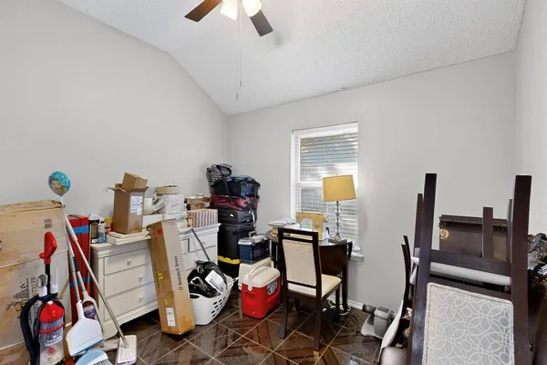 a bedroom with a bed and a lamp on dresser