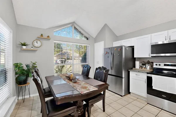 a view of a dining room with furniture window and outside view