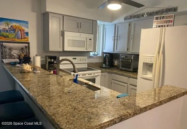 a kitchen with refrigerator and a sink