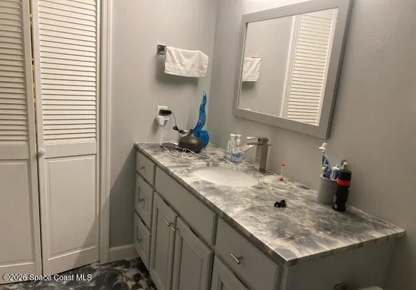 a white toilet next to a bathroom sink