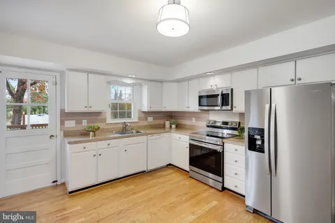 a kitchen with stainless steel appliances granite countertop a stove and a refrigerator