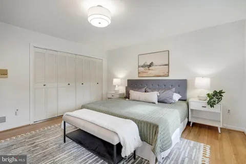 a bedroom with a bed and a table chair