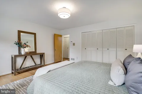 a bathroom with a granite countertop toilet and a sink