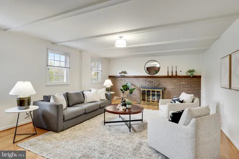 a living room with furniture a lamp and a fireplace