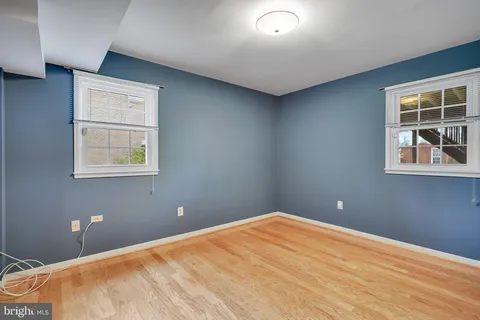 a bathroom with a granite countertop toilet sink and mirror