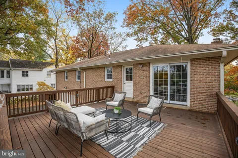 a view of a deck with couches and wooden floor