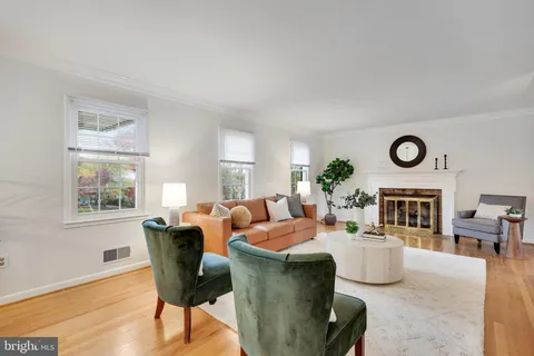 a living room with fireplace furniture and a window