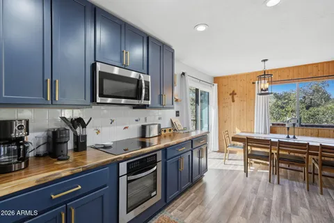 a kitchen with sink cabinets and wooden floor