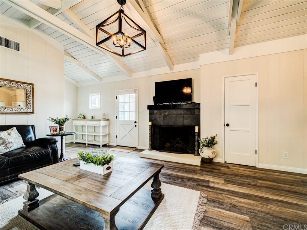 3758 Chatwin Avenue Long Beach, CA 90808 - Photo 14 of 34 a living room with furniture a flat screen tv and a fireplace