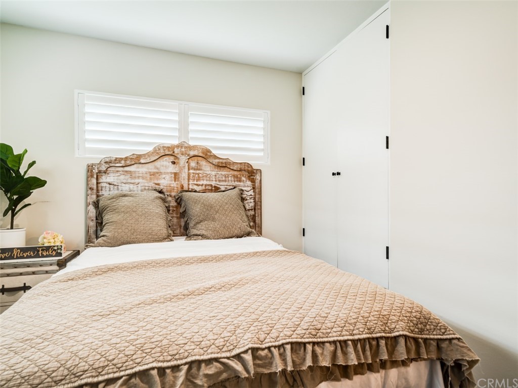 3758 Chatwin Avenue Long Beach, CA 90808 - Photo 19 of 34 a bedroom with a large bed and a potted plant