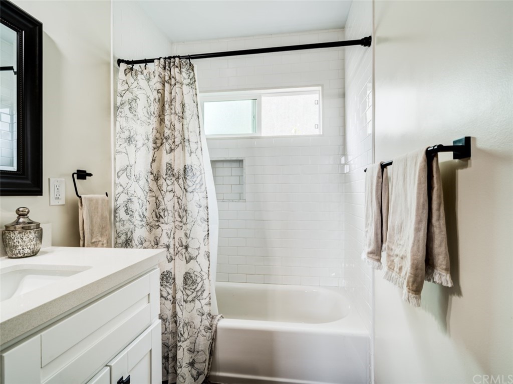 3758 Chatwin Avenue Long Beach, CA 90808 - Photo 21 of 34 a bathroom with a bathtub and a shower