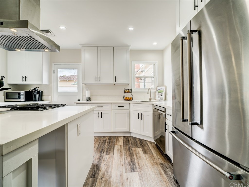 3758 Chatwin Avenue Long Beach, CA 90808 - Photo 6 of 34 a kitchen with a refrigerator a sink and a stove top oven