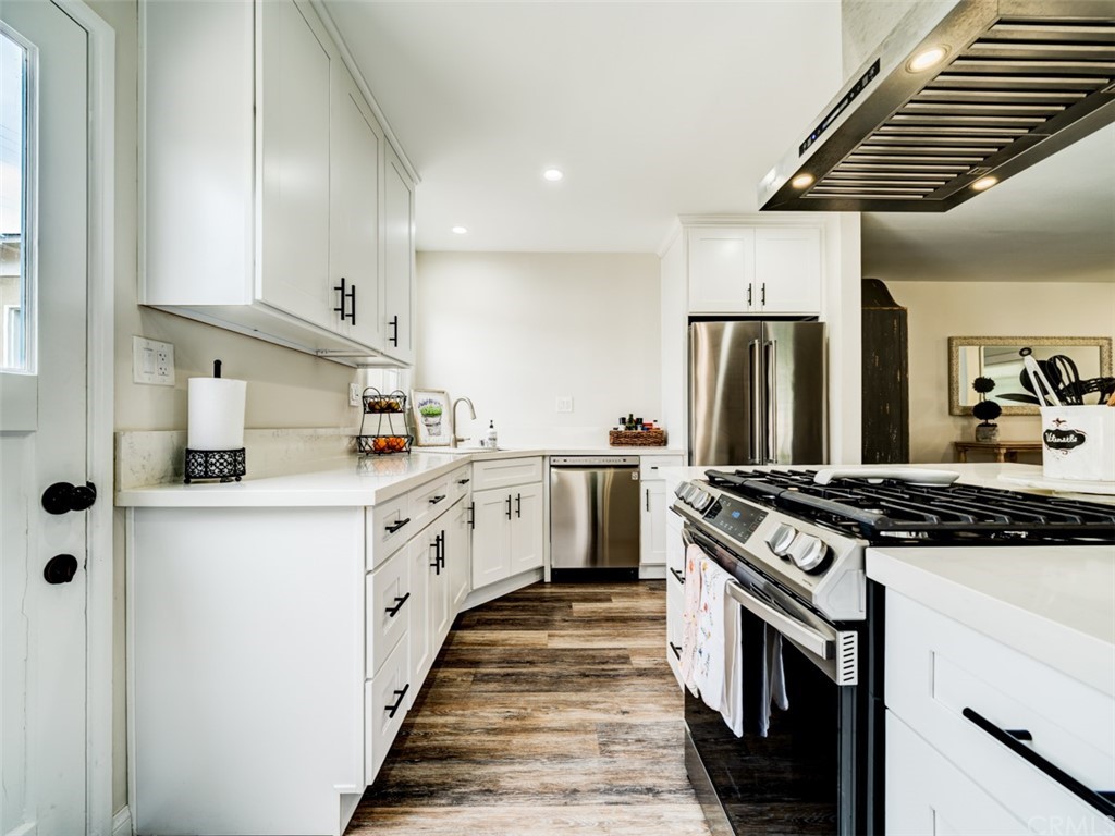 3758 Chatwin Avenue Long Beach, CA 90808 - Photo 8 of 34 a kitchen with white cabinets and white appliances