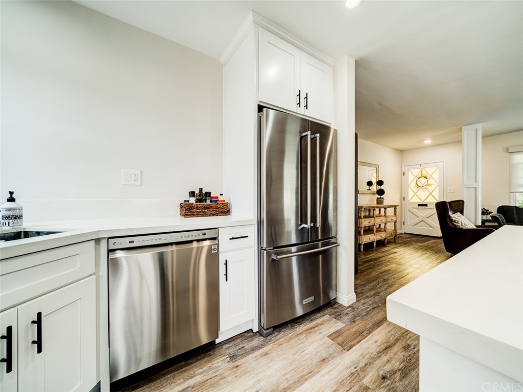 3758 Chatwin Avenue Long Beach, CA 90808 - Photo 9 of 34 a kitchen with stainless steel appliances a refrigerator and wooden floor