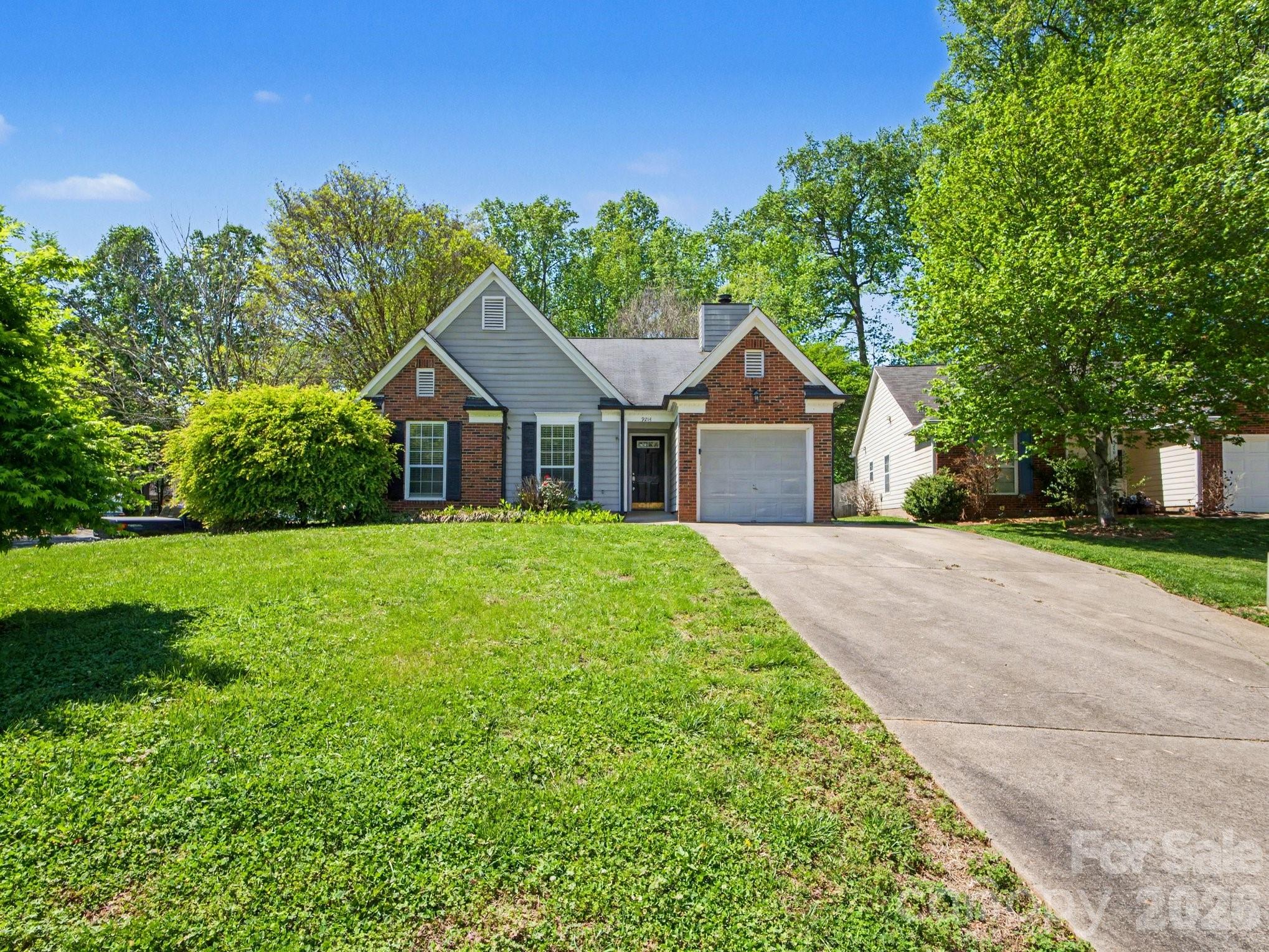 a front view of house with yard and green space