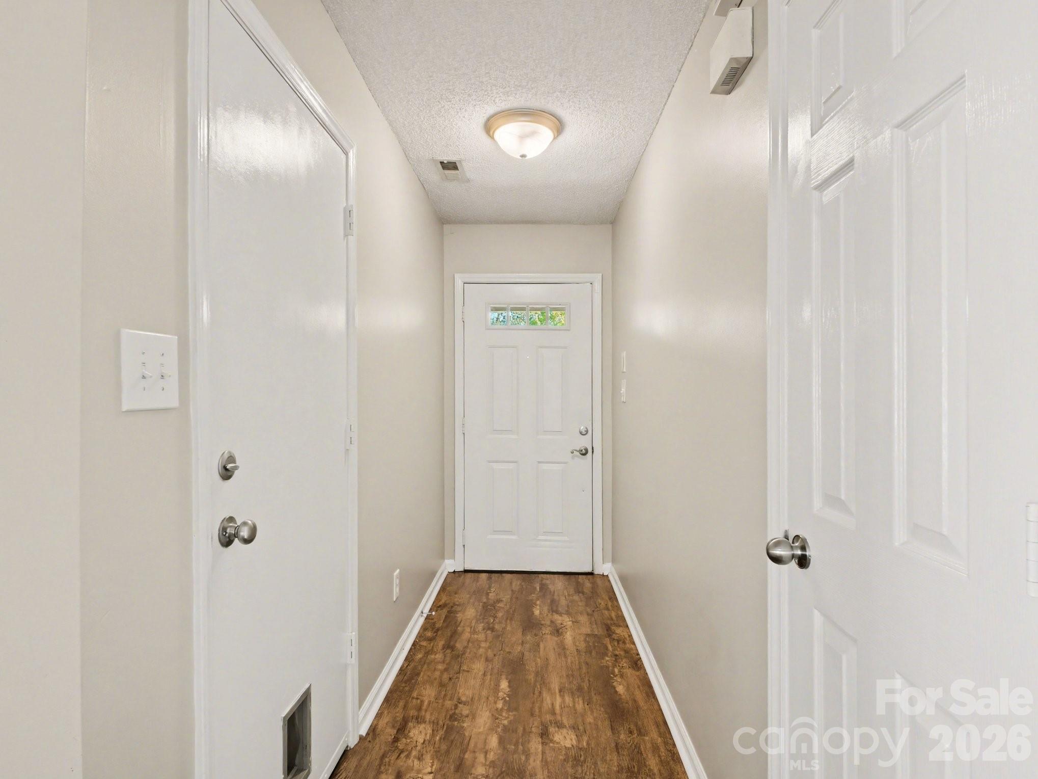 9214 Rotherham Lane Charlotte, NC 28216 - Photo 11 of 20 a view of a hallway with wooden floor and closet area
