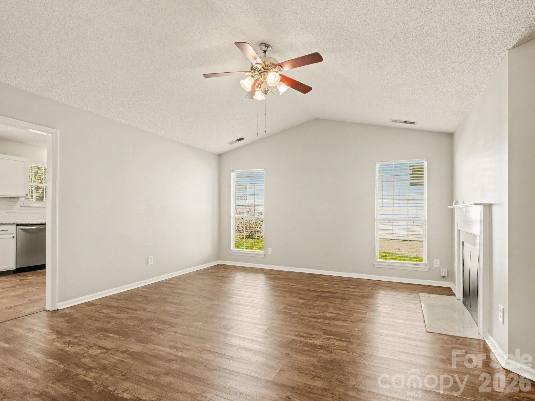 9214 Rotherham Lane Charlotte, NC 28216 - Photo 13 of 20 a view of an empty room with wooden floor and a window