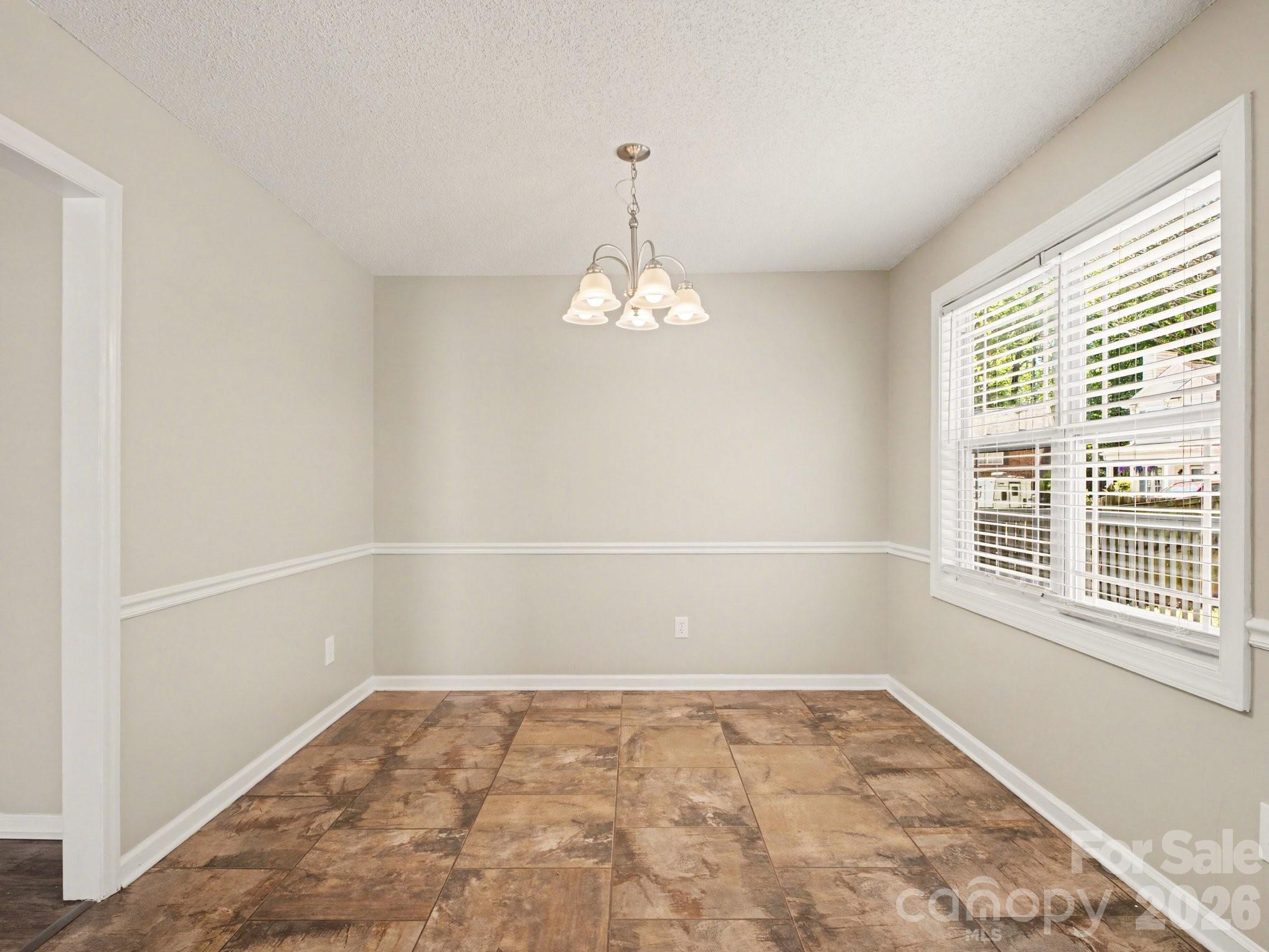 9214 Rotherham Lane Charlotte, NC 28216 - Photo 14 of 20 an empty room with a window