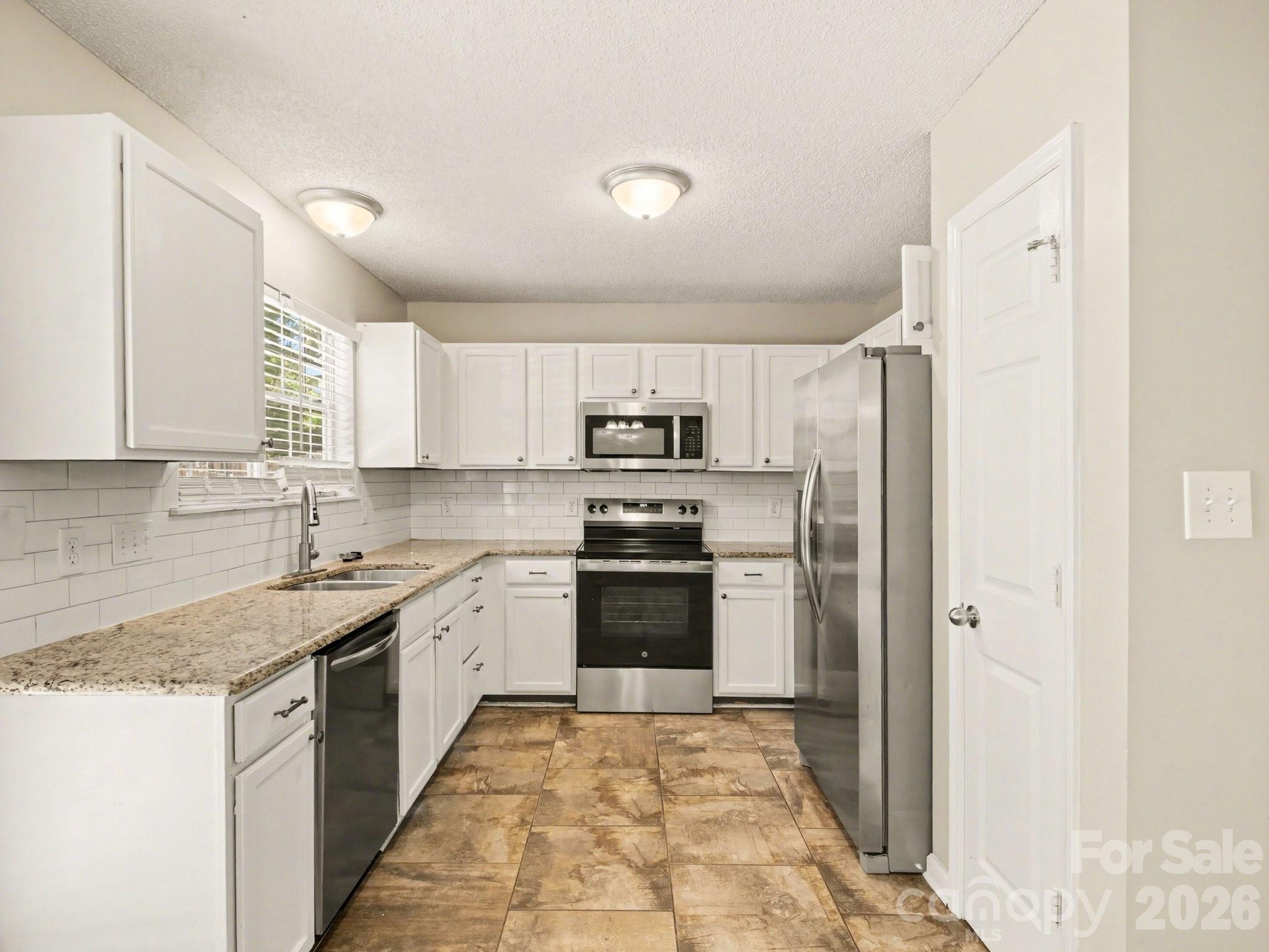 9214 Rotherham Lane Charlotte, NC 28216 - Photo 15 of 20 a kitchen with a sink stove and refrigerator
