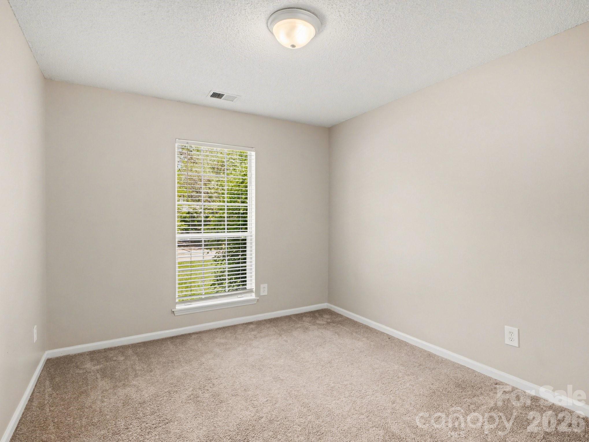 9214 Rotherham Lane Charlotte, NC 28216 - Photo 18 of 20 an empty room with a window