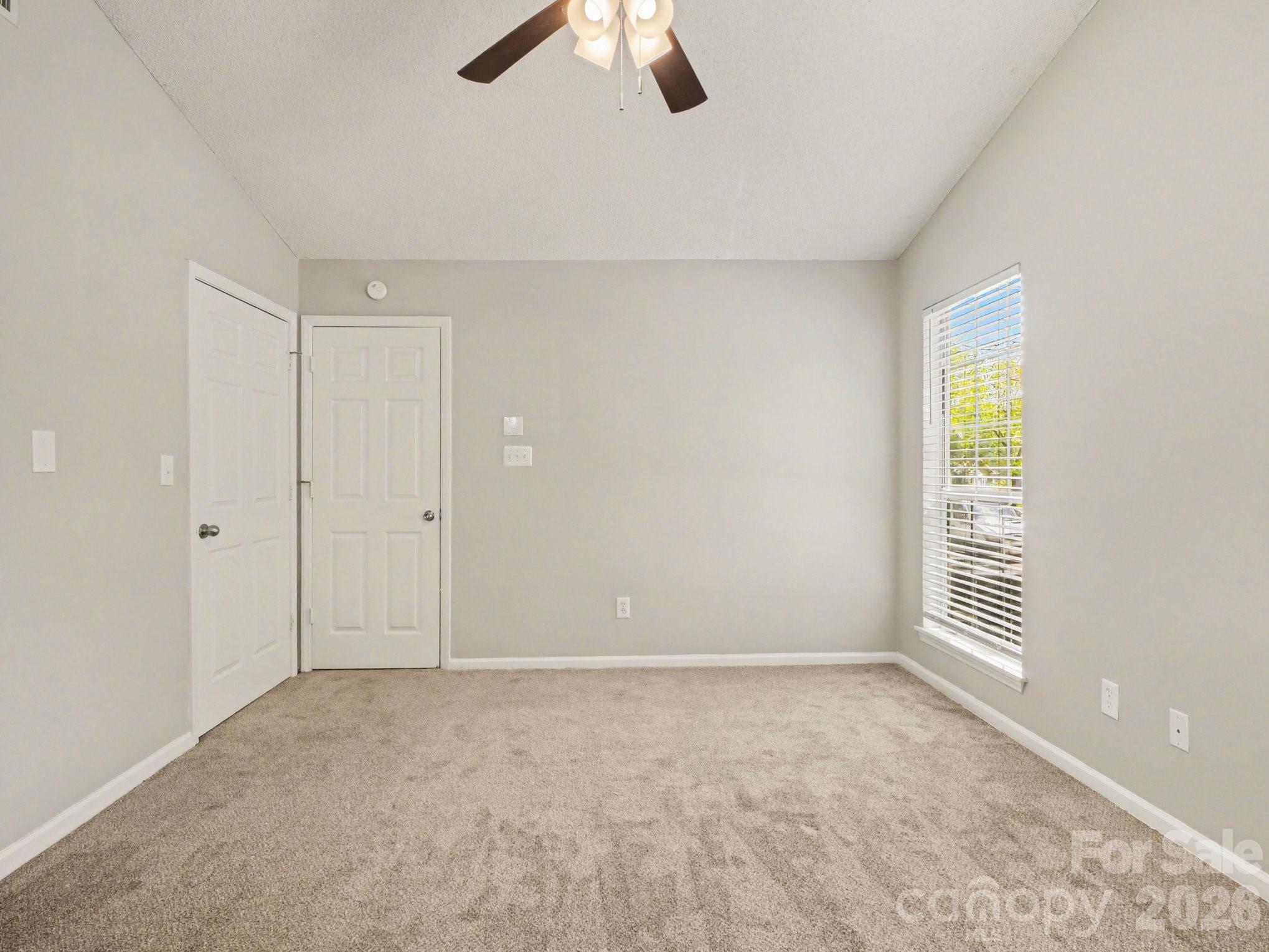9214 Rotherham Lane Charlotte, NC 28216 - Photo 6 of 20 wooden floor in an empty room with a window