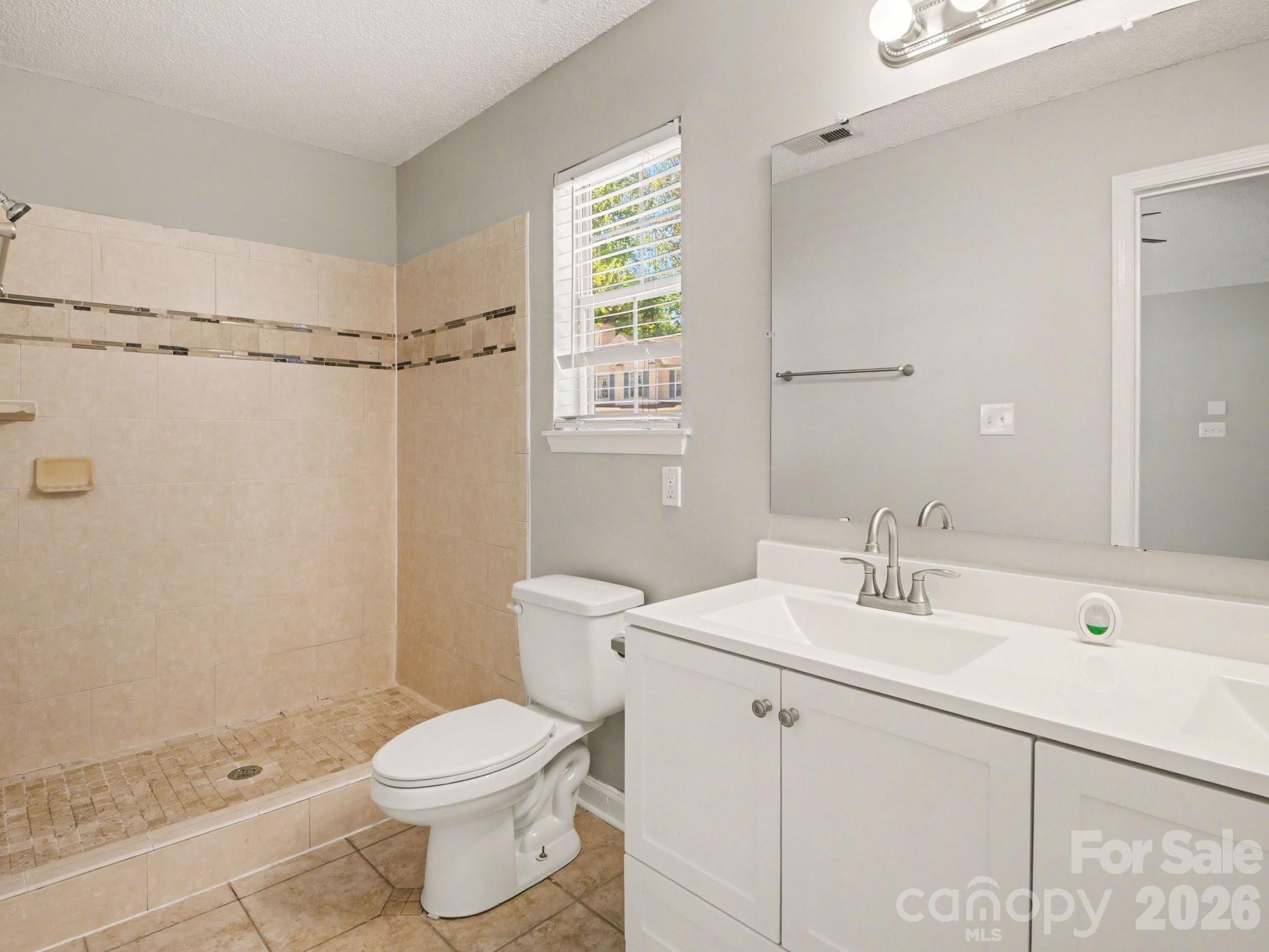 9214 Rotherham Lane Charlotte, NC 28216 - Photo 8 of 20 a bathroom with a sink toilet and shower