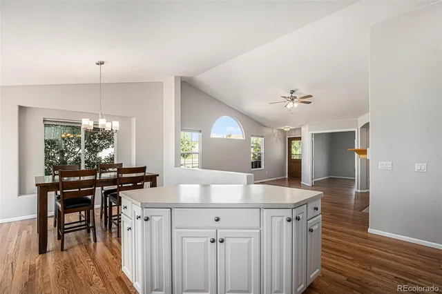 a view of deck with wooden floor and fence next to a yard