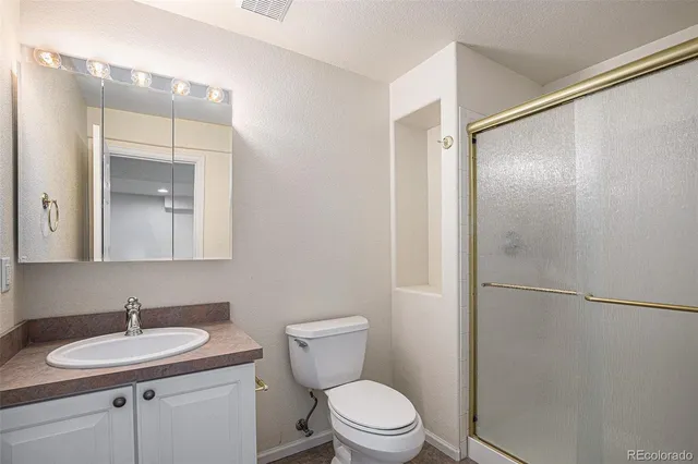 a bathroom with a sink toilet and shower
