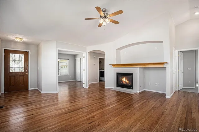 wooden floor fireplace and windows in a room