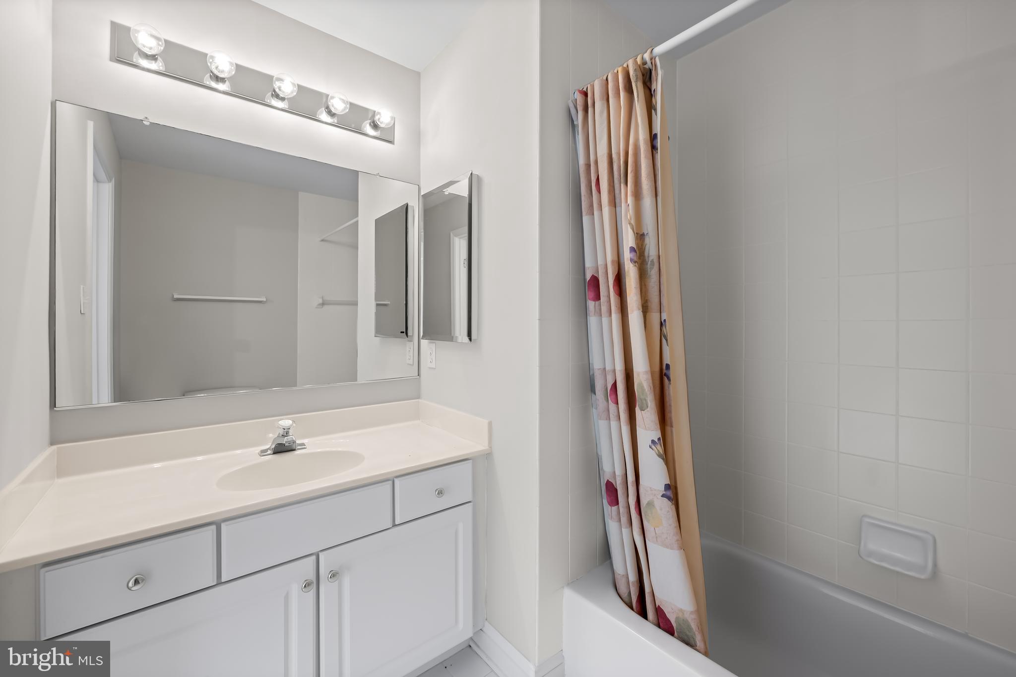 24 Roland Green, Unit 12 Baltimore, MD 21210 - Photo 32 of 53 a bathroom with a sink and a mirror