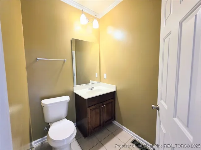 a bathroom with a toilet sink vanity and mirror