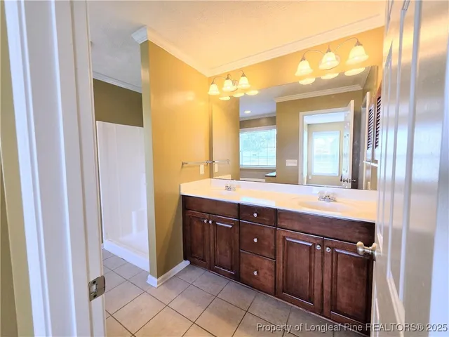 a spacious bathroom with a double vanity sink and a mirror