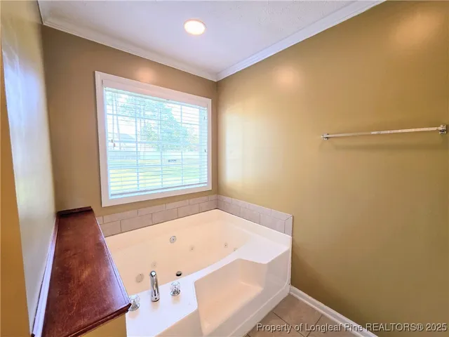 a bath room with a window and a bath tub