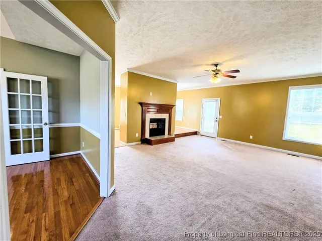 a view of empty room with a fireplace