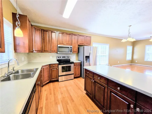 a kitchen with wooden cabinets and stainless steel appliances