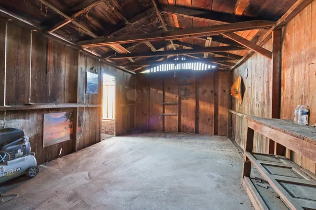 a view of an empty room with wooden walls