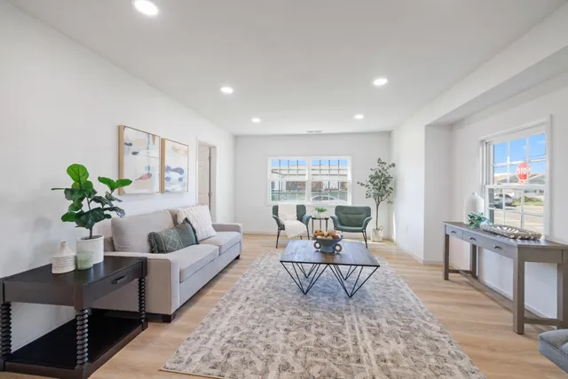 a living room with furniture and a potted plant